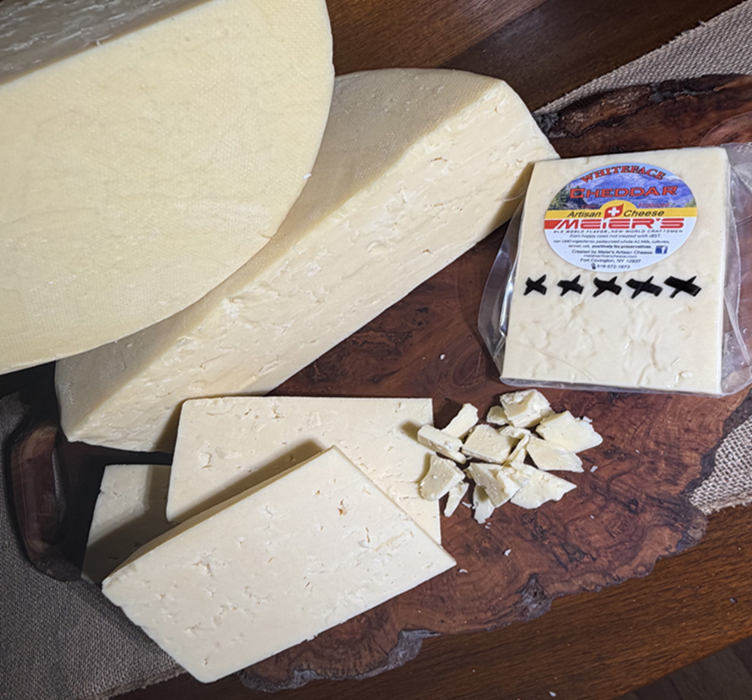 Sliced white cheese on rustic wooden board