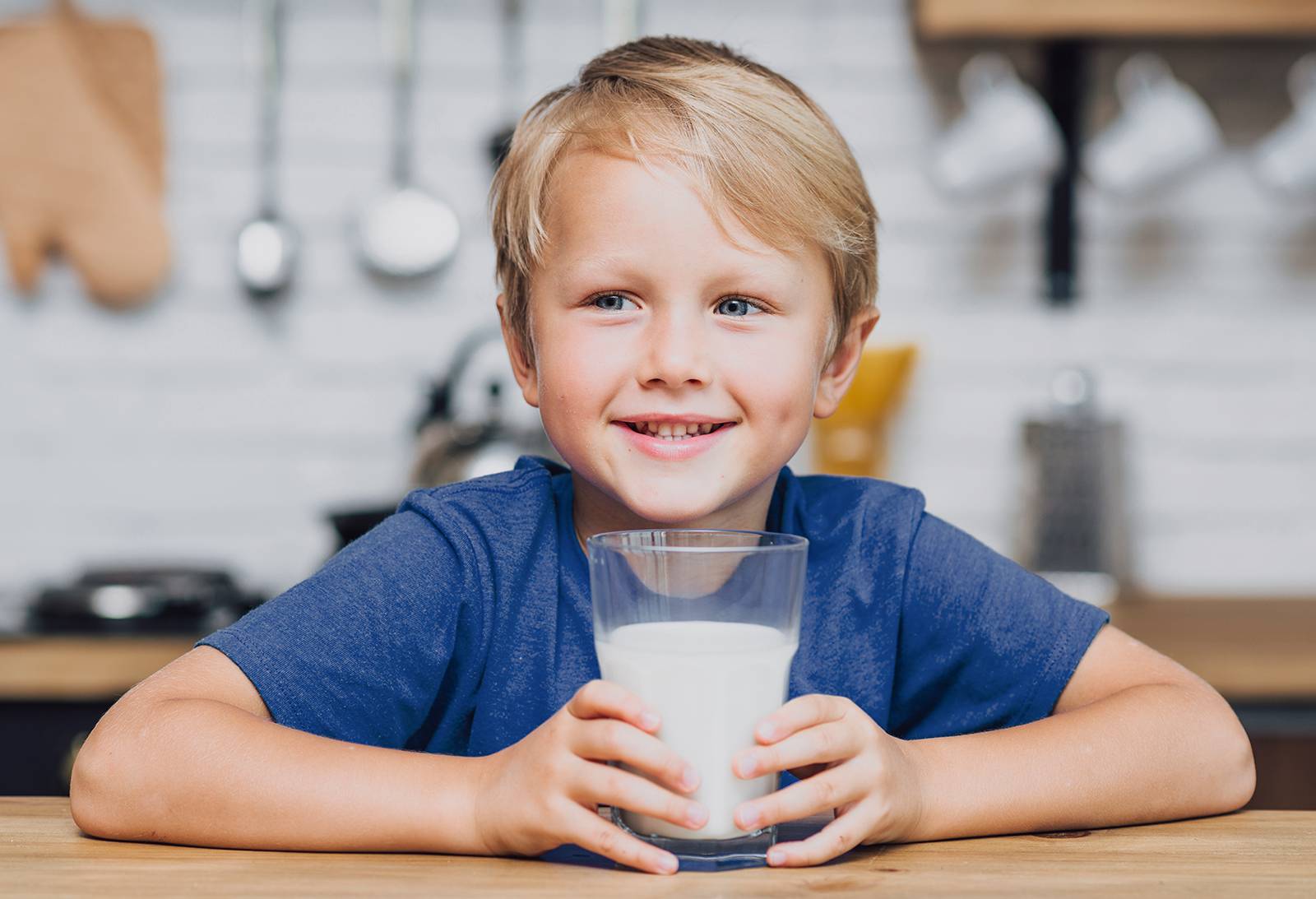 Child smiling with glass of milk