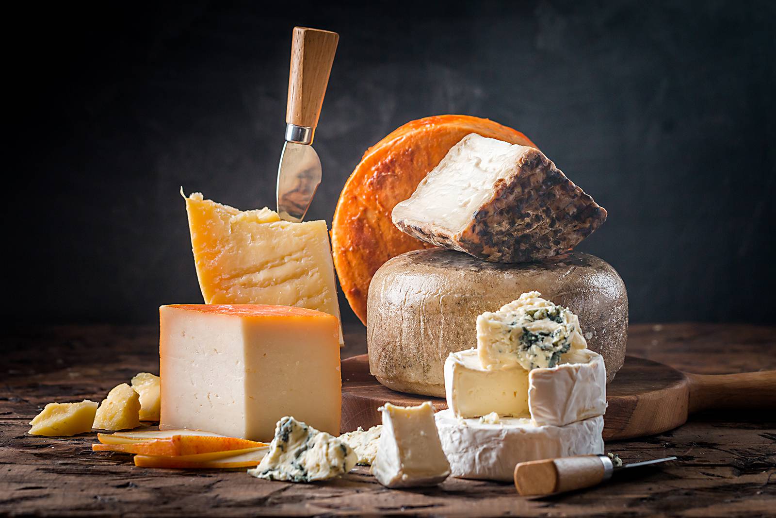 Variety of cheeses with knives
