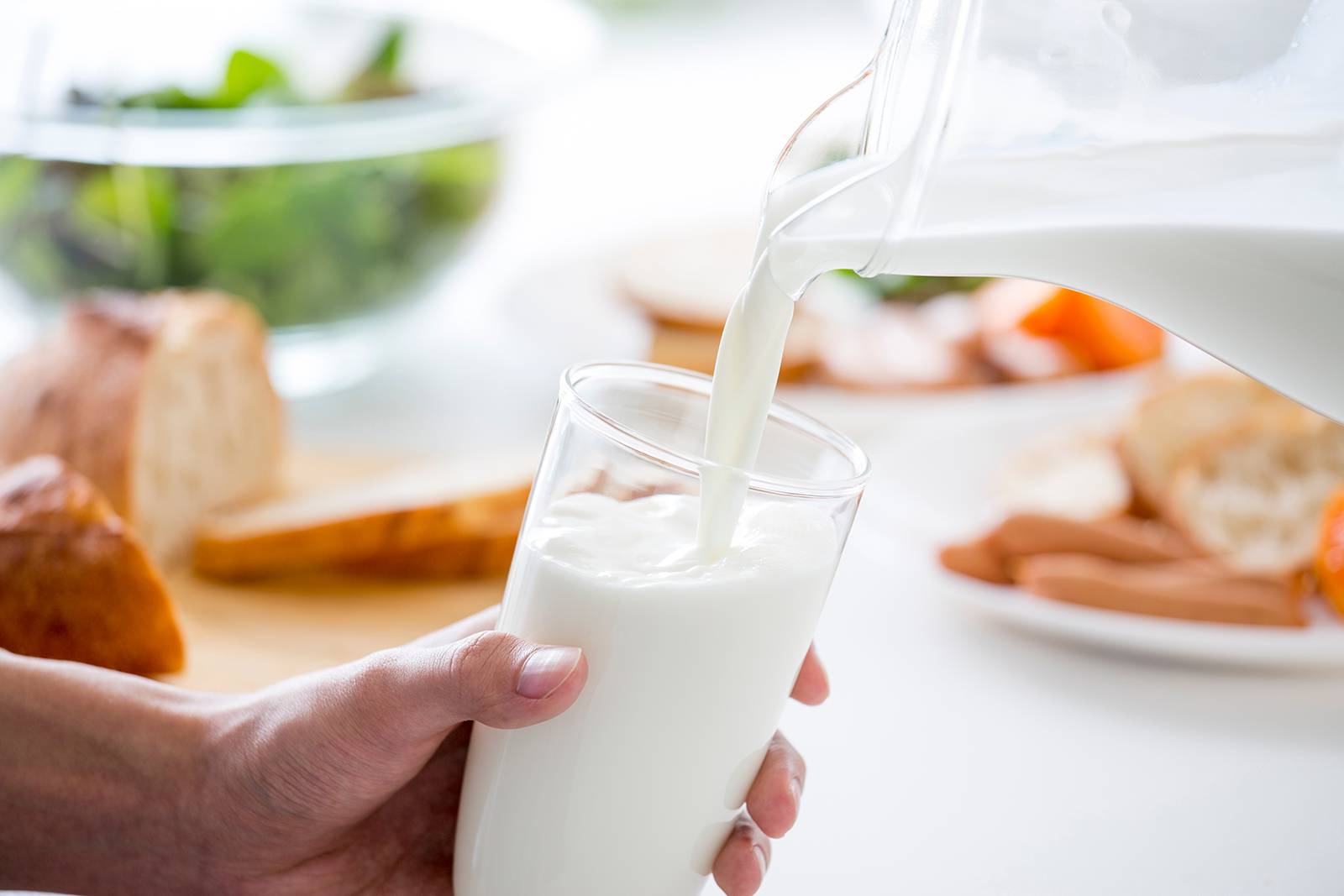 Fresh milk being poured into glass